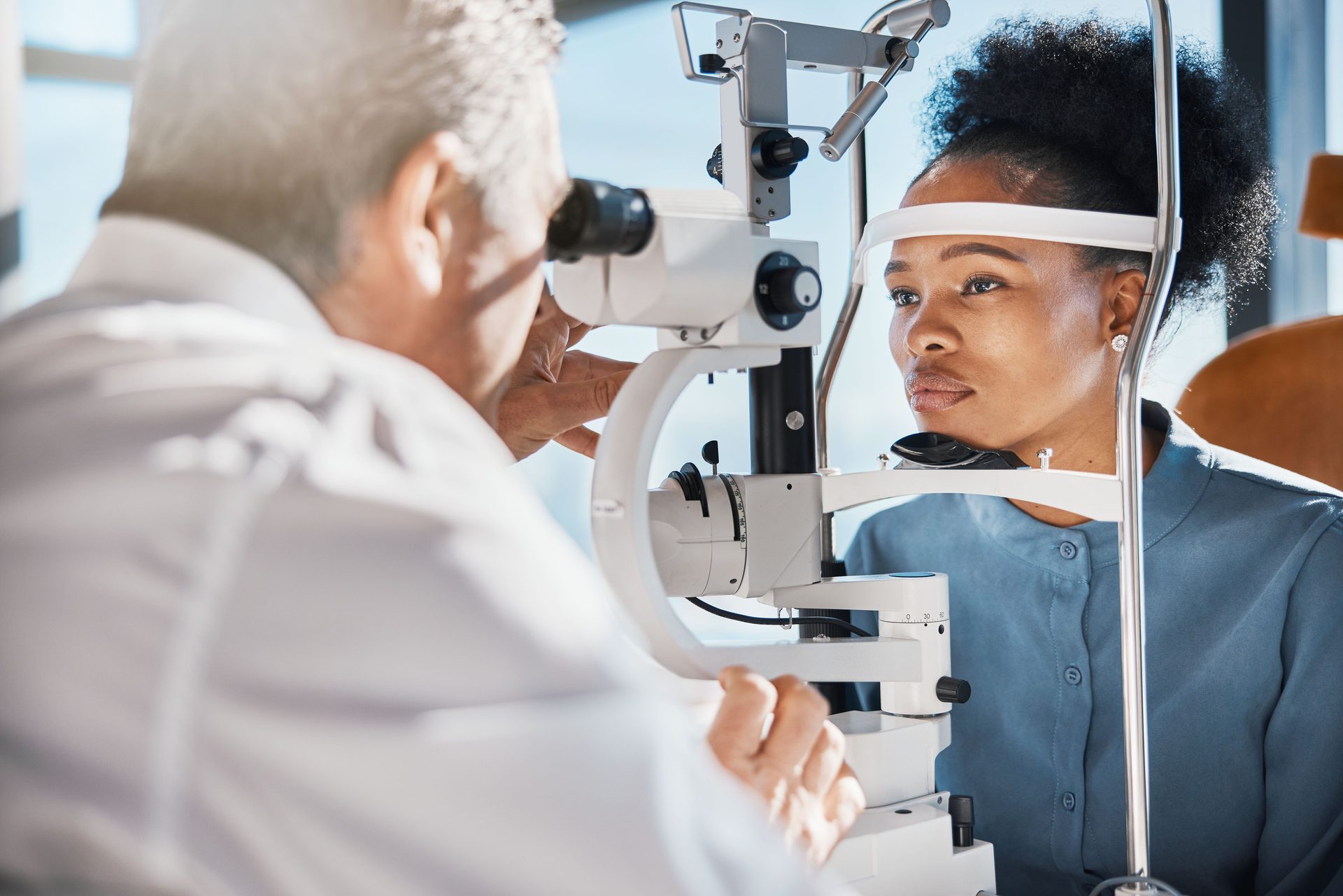 Ophthalmologist performing a slit-lamp examination β diagnostic equipment in use